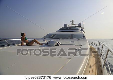 "Leonardo II, a cruiser built by Azimut, type of boat: Leonardo 98, length: 30. 15 m, built in 2004, a young woman wearing a bikini sitting on the foredeck, French Riviera, France, Mediterranean Sea, Europe" View Large Photo Image Stock Photograph - "Leonardo II, a cruiser built by Azimut, type of boat: Leonardo 98, length: 30. 15 m, built in 2004, a young woman wearing a bikini sitting on the foredeck, French Riviera, France, Mediterranean Sea, Europe". Fotosearch
