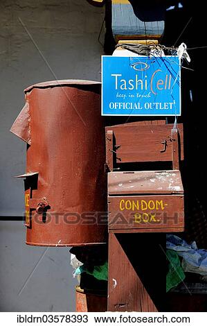Stock Image - "Letter box, advertising sign and a box of condoms labelled """"Condom Box"""", Yadi, Mongar District, Bhutan, Asia". Fotosearch