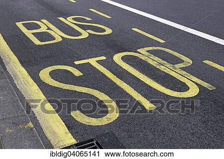 Stock Image - "Lettering """"Bus Stop"""" painted onto a tarmac road, London, England, United Kingdom, Europe". Fotosearch