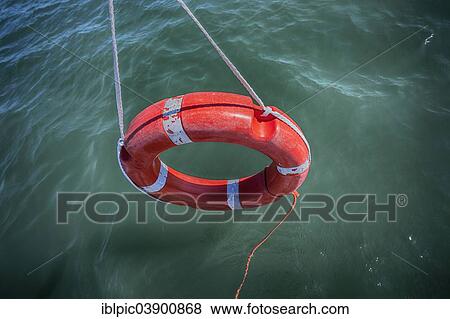 Stock Photo - Lifebuoy dangling over water. Fotosearch