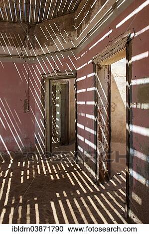 "Light passing through the laths of a decaying house in the former diamond miners settlement that is slowly covered by the sand of the Namib Desert, Kolmanskop, ÇKaras, Namibia, Africa" View Large Photo Image Stock Image - "Light passing through the laths of a decaying house in the former diamond miners settlement that is slowly covered by the sand of the Namib Desert, Kolmanskop, ÇKaras, Namibia, Africa". Fotosearch