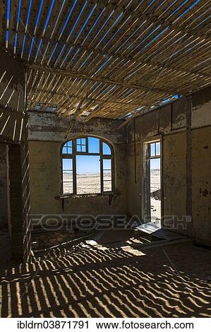 "Light passing through the laths of a decaying house in the former diamond miners settlement that is slowly covered by the sand of the Namib Desert, Kolmanskop, ÇKaras, Namibia, Africa" View Large Photo Image Stock Image - "Light passing through the laths of a decaying house in the former diamond miners settlement that is slowly covered by the sand of the Namib Desert, Kolmanskop, ÇKaras, Namibia, Africa". Fotosearch