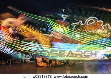 Stock Photo - "Light trails, ride at night, Munich Spring Festival, Theresienwiese, Munich, Bavaria, Germany, Europe". Fotosearch