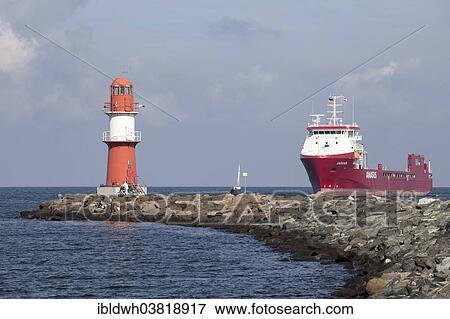 "Lighthouse and a cargo ship, Warnemuende, Rostock, Mecklenburg-Vorpommern, Germany, Europe" View Large Photo Image Stock Photo - "Lighthouse and a cargo ship, Warnemuende, Rostock, Mecklenburg-Vorpommern, Germany, Europe". Fotosearch