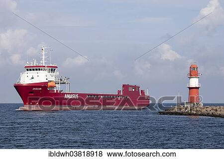 Stock Photo - "Lighthouse and a cargo ship, Warnemuende, Rostock, Mecklenburg-Vorpommern, Germany, Europe". Fotosearch
