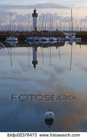 "Lighthouse and boats reflected in the eastern harbor in the early morning, Port-Haliguen in Quiberon, southern Brittany, Bretagne, France, Europe" View Large Photo Image Stock Image - "Lighthouse and boats reflected in the eastern harbor in the early morning, Port-Haliguen in Quiberon, southern Brittany, Bretagne, France, Europe". Fotosearch