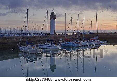 "Lighthouse and boats reflected in the eastern harbor in the early morning, Port-Haliguen in Quiberon, southern Brittany, Bretagne, France, Europe" View Large Photo Image Stock Photo - "Lighthouse and boats reflected in the eastern harbor in the early morning, Port-Haliguen in Quiberon, southern Brittany, Bretagne, France, Europe". Fotosearch
