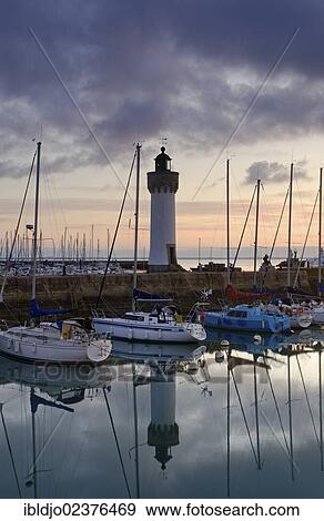 "Lighthouse and boats reflected in the eastern harbor in the early morning, Port-Haliguen in Quiberon, southern Brittany, Bretagne, France, Europe" View Large Photo Image Stock Photo - "Lighthouse and boats reflected in the eastern harbor in the early morning, Port-Haliguen in Quiberon, southern Brittany, Bretagne, France, Europe". Fotosearch