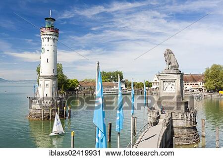 Stock Image - Lighthouse and the Bavarian lion at the harbor entrance of Lindau on Lake Constance, Bavaria, Germany, Europe, PublicGround, Europe. Fotosearch