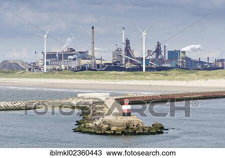 "Lighthouse at the harbor entrance of Ijmuiden, wind turbines and the Tata steel plant at the back, North Holland, Netherlands, Europe" View Large Photo Image Stock Image - "Lighthouse at the harbor entrance of Ijmuiden, wind turbines and the Tata steel plant at the back, North Holland, Netherlands, Europe". Fotosearch