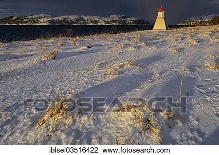 "Lighthouse in sunlight against dark sky in winter fjord, Tromso, ‪Troms, Northern Norway, Norway, Europe" View Large Photo Image Stock Image - "Lighthouse in sunlight against dark sky in winter fjord, Tromso, ‪Troms, Northern Norway, Norway, Europe". Fotosearch