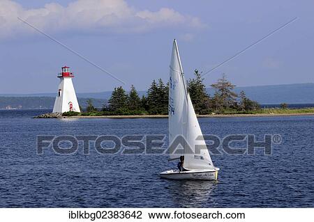"Lighthouse with sloop sail boat, Bras d'Or Lake, Baddeck, Cape Breton, Nova Scotia, Canada, North America" View Large Photo Image Stock Image - "Lighthouse with sloop sail boat, Bras d'Or Lake, Baddeck, Cape Breton, Nova Scotia, Canada, North America". Fotosearch