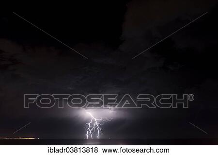 Stock Photo - Lightning over the sea. Fotosearch