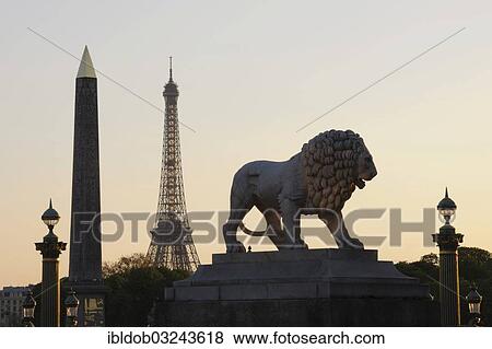 Stock Photo - "Lion sculpture and obelisk on the Place de la Concorde, Eiffel Tower, Tour Eiffel at back, Paris, Ile-de-France, France, Europe". Fotosearch