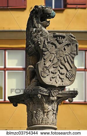 "Lion sculpture holding a shield with the double-headed eagle at Loewenbrunnen, Lion's fountain, Dinkelsbuhl, Middle Franconia, Bavaria, Germany, Europe" View Large Photo Image Picture - "Lion sculpture holding a shield with the double-headed eagle at Loewenbrunnen, Lion's fountain, Dinkelsbuhl, Middle Franconia, Bavaria, Germany, Europe". Fotosearch