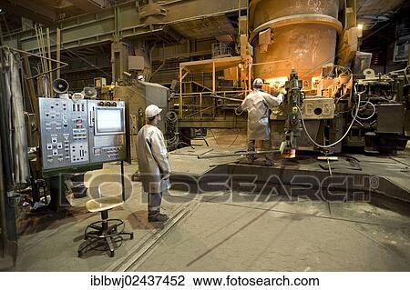 Stock Image - "Liquid steel pouring from the ladle into the casting, casting plant, Salzgitter AG Steel Mill, Salzgitter, Lower Saxony, Germany, Europe". Fotosearch