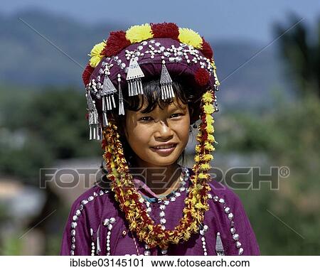 Stock Image - "Lisu girl wearing a colourful headdress and the traditional costume of the mountain people, portrait, Mae Sai, Chiang Rai Province, Northern Thailand, Thailand, Asia". Fotosearch