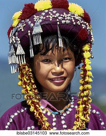Stock Image - "Lisu girl wearing a colourful headdress and the traditional costume of the mountain people, portrait, Mae Sai, Chiang Rai Province, Northern Thailand, Thailand, Asia". Fotosearch