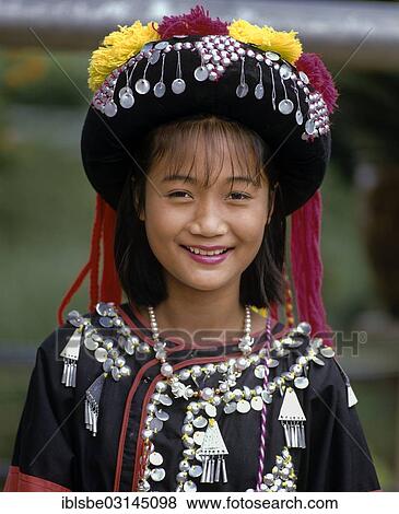Stock Photo - "Lisu girl wearing a colourful headdress and the traditional costume of the mountain people, portrait, Mae Sai, Chiang Rai Province, Northern Thailand, Thailand, Asia". Fotosearch