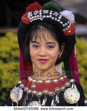Stock Photograph - "Lisu girl wearing a colourful headdress and the traditional costume of the mountain people, portrait, Mae Sai, Chiang Rai Province, Northern Thailand, Thailand, Asia". Fotosearch