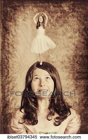 Stock Photography - "Little ballerina dancing on the head of a girl, photocomposing". Fotosearch