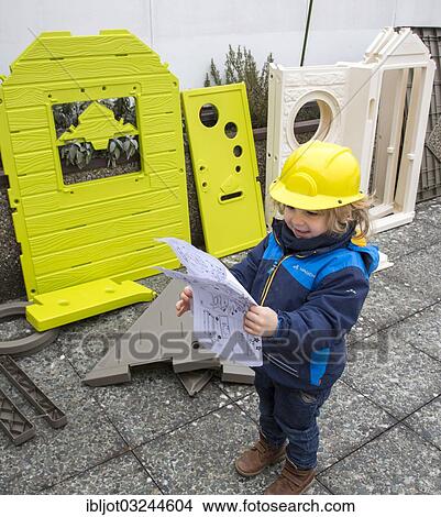 "Little boy, 3 years, with toy hard hat, helping to build a playhouse, studying the blueprint" View Large Photo Image Picture - "Little boy, 3 years, with toy hard hat, helping to build a playhouse, studying the blueprint". Fotosearch