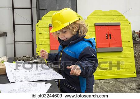 "Little boy, 3 years, with toy hard hat, helping to build a playhouse, studying the blueprint" View Large Photo Image Stock Photo - "Little boy, 3 years, with toy hard hat, helping to build a playhouse, studying the blueprint". Fotosearch