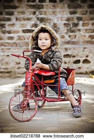 "Little boy riding a tricycle in Yangon, Burma also known as Myanmar, Southeast Asia, Asia" View Large Photo Image Stock Photo - "Little boy riding a tricycle in Yangon, Burma also known as Myanmar, Southeast Asia, Asia". Fotosearch