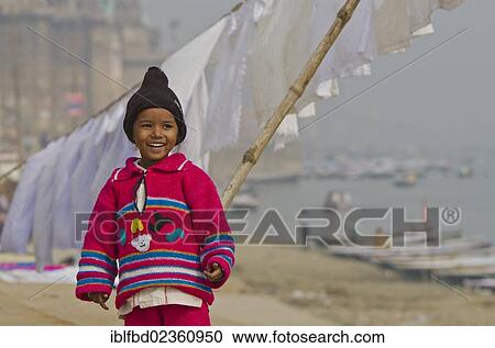 Stock Image - "Little boy standing at the ghats, Varanasi, India, Asia". Fotosearch