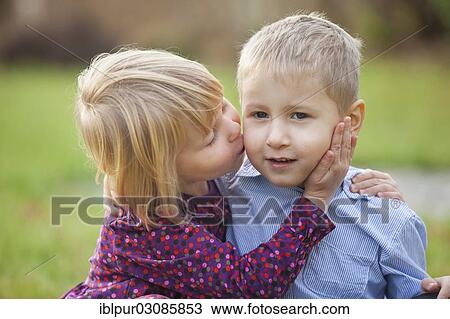 "Little girl kissing a little boy, Germany, Europe" View Large Photo Image Stock Image - "Little girl kissing a little boy, Germany, Europe". Fotosearch
