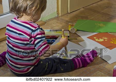 Stock Image - "Little girl painting with acrylic paint, Germany, Europe". Fotosearch