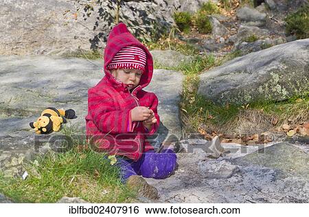 "Little girl playing between rocks in the sand, Ostrov, Czech Republic, Europe" View Large Photo Image Stock Photograph - "Little girl playing between rocks in the sand, Ostrov, Czech Republic, Europe". Fotosearch