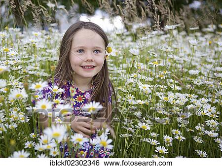 Stock Photograph - "Little girl, three years, sitting in a flower meadow with many daisies, Rosenheim, Bavaria, Germany, Europe". Fotosearch