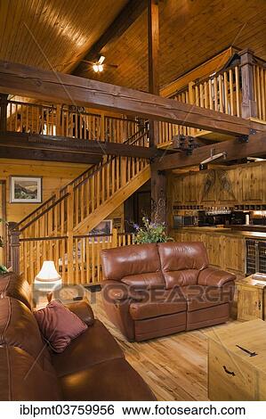 Stock Photograph - "Living room inside a Canadiana Cottage, a white pine log home, Quebec Province, Canada, North America". Fotosearch