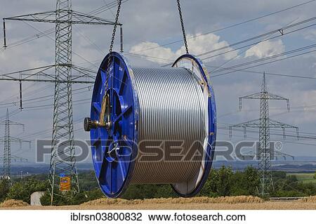 "Loading a roll of conductive cable after work on a high-voltage transmission mast, Monchenholzhausen, Thuringia, Germany, Europe" View Large Photo Image Stock Image - "Loading a roll of conductive cable after work on a high-voltage transmission mast, Monchenholzhausen, Thuringia, Germany, Europe". Fotosearch