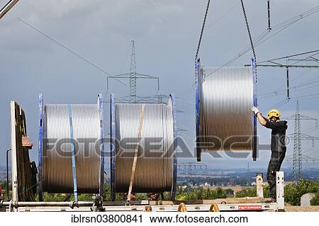 "Loading of rolls of conductive cable after work on a high-voltage transmission mast, Monchenholzhausen, Thuringia, Germany, Europe" View Large Photo Image Stock Image - "Loading of rolls of conductive cable after work on a high-voltage transmission mast, Monchenholzhausen, Thuringia, Germany, Europe". Fotosearch