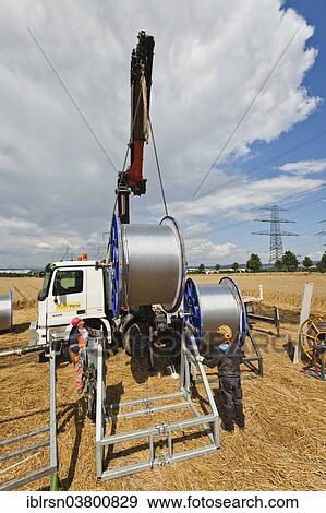 "Loading of rolls of conductive cable after work on a high-voltage transmission mast, Monchenholzhausen, Thuringia, Germany, Europe" View Large Photo Image Stock Photo - "Loading of rolls of conductive cable after work on a high-voltage transmission mast, Monchenholzhausen, Thuringia, Germany, Europe". Fotosearch