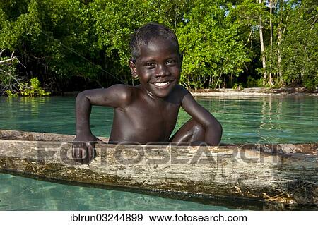 "Local boy in a canoe in the Marovo Lagoon, Marovo Lagoon, Western Province, Solomon Islands, Oceania" View Large Photo Image Stock Photo - "Local boy in a canoe in the Marovo Lagoon, Marovo Lagoon, Western Province, Solomon Islands, Oceania". Fotosearch