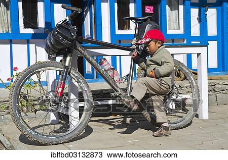 "Local boy playing with the mountainbike of a tourist, Danakyu, Annapurna Region, Nepal, Asia" View Large Photo Image Stock Image - "Local boy playing with the mountainbike of a tourist, Danakyu, Annapurna Region, Nepal, Asia". Fotosearch
