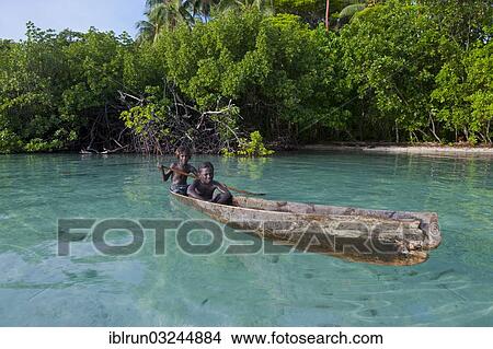 "Local boys in a canoe in the Marovo Lagoon, Marovo Lagoon, Western Province, Solomon Islands, Oceania" View Large Photo Image Picture - "Local boys in a canoe in the Marovo Lagoon, Marovo Lagoon, Western Province, Solomon Islands, Oceania". Fotosearch