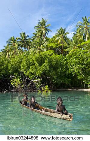 "Local boys in a canoe in the Marovo Lagoon, Marovo Lagoon, Western Province, Solomon Islands, Oceania" View Large Photo Image Stock Photo - "Local boys in a canoe in the Marovo Lagoon, Marovo Lagoon, Western Province, Solomon Islands, Oceania". Fotosearch