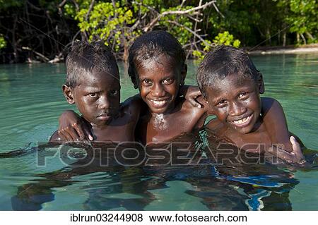 "Local boys in the water of the Marovo Lagoon, Marovo Lagoon, Western Province, Solomon Islands, Oceania" View Large Photo Image Stock Photo - "Local boys in the water of the Marovo Lagoon, Marovo Lagoon, Western Province, Solomon Islands, Oceania". Fotosearch