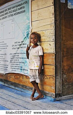 "Local child standing against a wooden wall, Arborek, Raja Ampat, West Papua, Indonesia, Asia" View Large Photo Image Stock Photo - "Local child standing against a wooden wall, Arborek, Raja Ampat, West Papua, Indonesia, Asia". Fotosearch