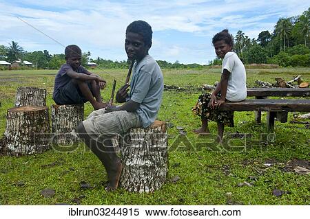"Local children waiting for the airplane at Seghe Airport, Seghe, Solomon Islands, Oceania" View Large Photo Image Stock Photography - "Local children waiting for the airplane at Seghe Airport, Seghe, Solomon Islands, Oceania". Fotosearch