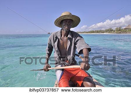 "Local fisherman in his boat, Dongwe Beach, Dongwe, Zanzibar, Tanzania, Africa" View Large Photo Image Stock Photo - "Local fisherman in his boat, Dongwe Beach, Dongwe, Zanzibar, Tanzania, Africa". Fotosearch
