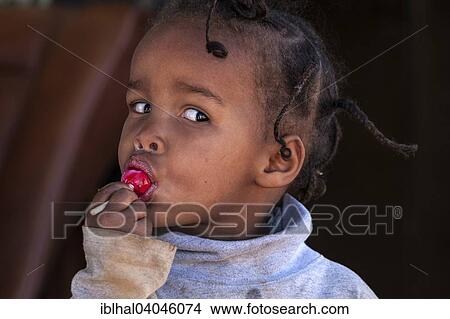 "Local girl with a red lollipop, portrait, Namibia, Africa" View Large Photo Image Picture - "Local girl with a red lollipop, portrait, Namibia, Africa". Fotosearch