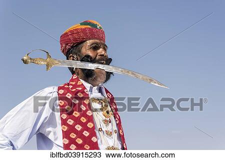 "Local man posing with a sword in his mouth, Rajput people, Bikaner, Rajasthan, India, Asia" View Large Photo Image Stock Image - "Local man posing with a sword in his mouth, Rajput people, Bikaner, Rajasthan, India, Asia". Fotosearch
