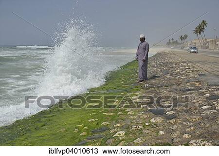 "Local man watching the surf at the corniche of Salalah during the monsoon season, or Khareef season, Salalah, Dhofar region, Orient, Oman, Asia" View Large Photo Image Stock Image - "Local man watching the surf at the corniche of Salalah during the monsoon season, or Khareef season, Salalah, Dhofar region, Orient, Oman, Asia". Fotosearch
