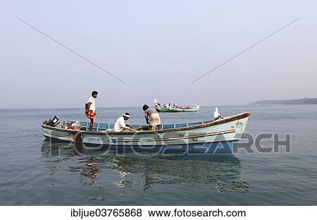 "Local mussel fishermen in their boat off the coast, Varkala, Kerala, India, Asia" View Large Photo Image Stock Photo - "Local mussel fishermen in their boat off the coast, Varkala, Kerala, India, Asia". Fotosearch