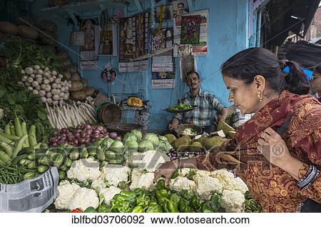 Stock Image - "Local woman buying cauliflower at the market, Shimla, Himachal Pradesh, India, Asia". Fotosearch